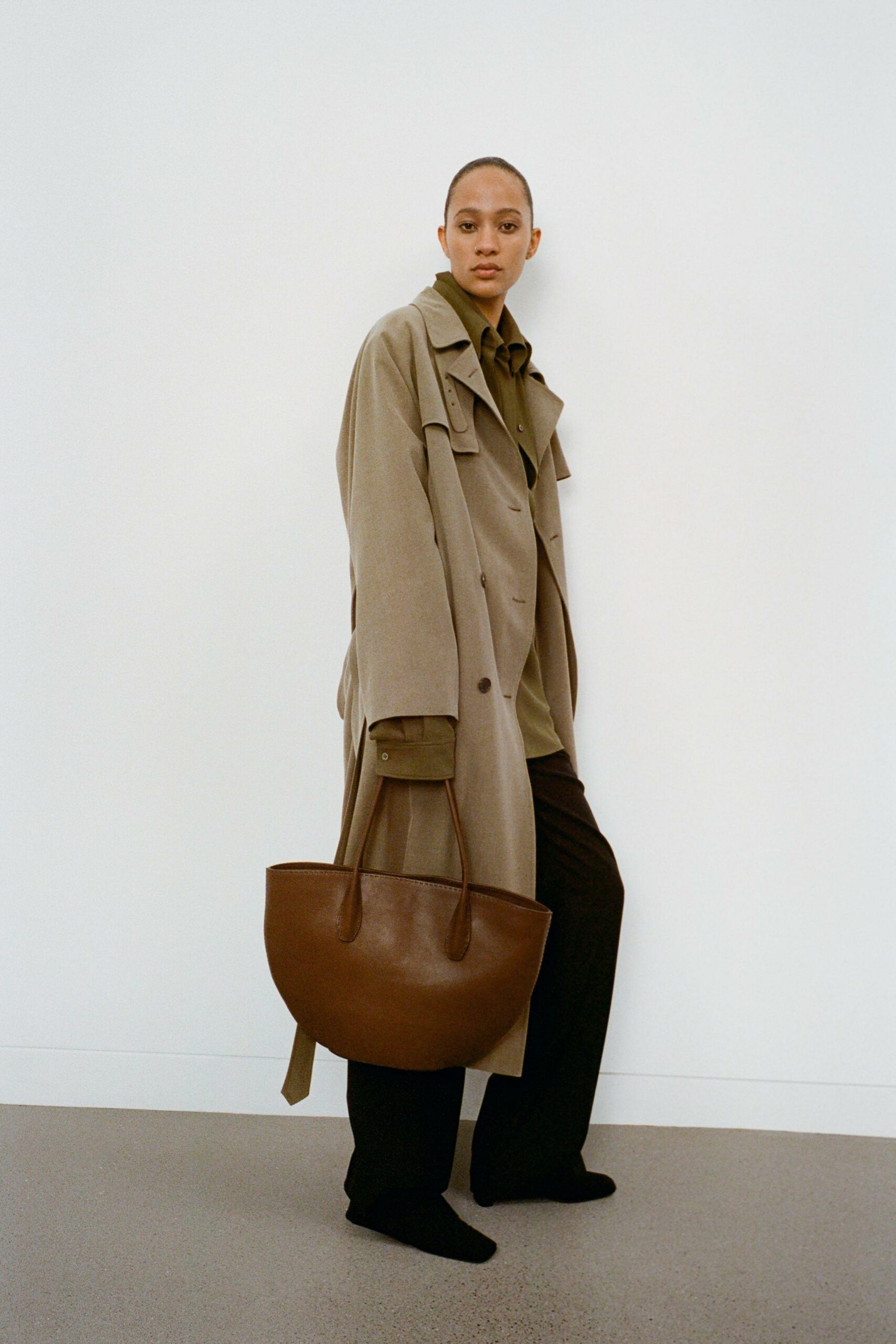 Neutral tote bag and minimalist loafers styled for a quiet luxury look