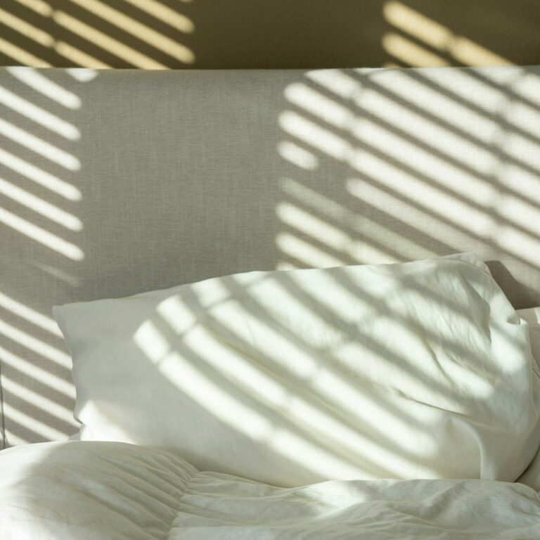 Comfortable Bedding for Guests: a neatly made bed with crisp white sheets and pillows
