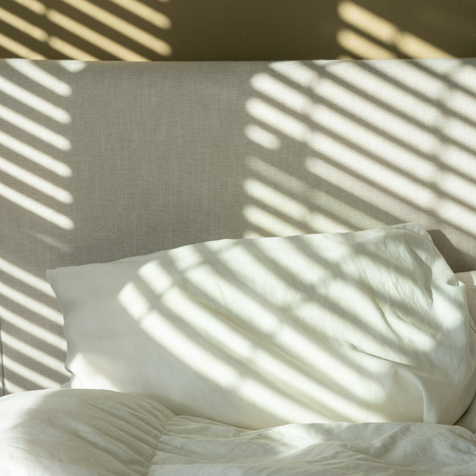 Comfortable Bedding for Guests: a neatly made bed with crisp white sheets and pillows