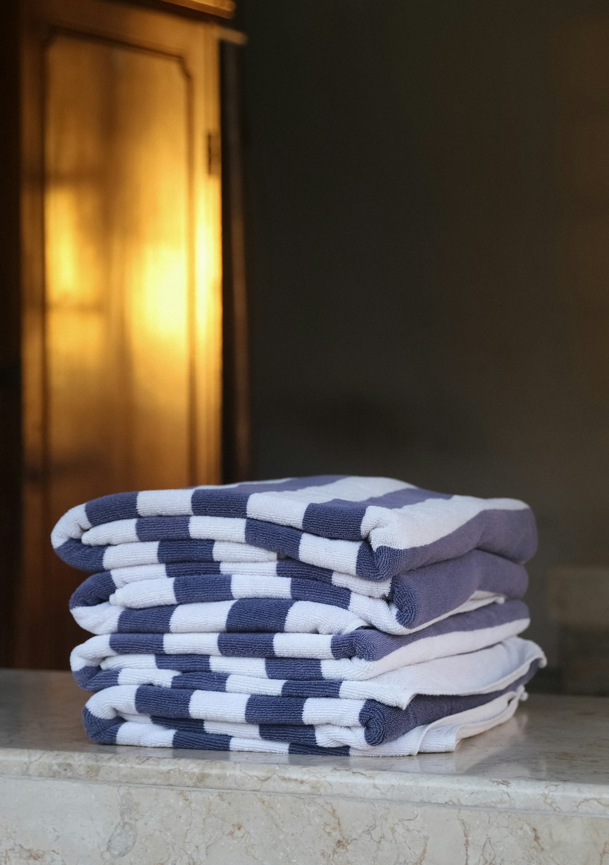 A neat stack of folded white towels on a counter