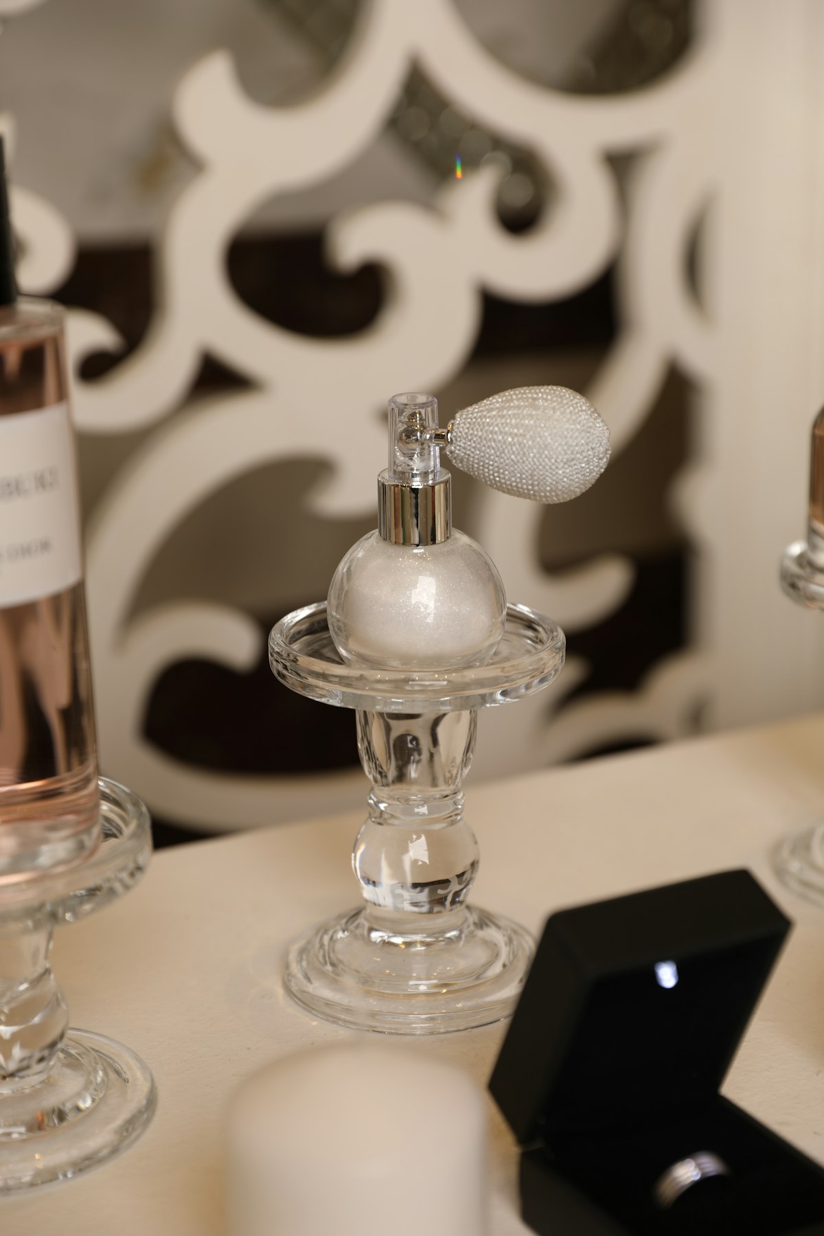 Perfumes that smell expensive displayed elegantly next to jewelry on a vanity